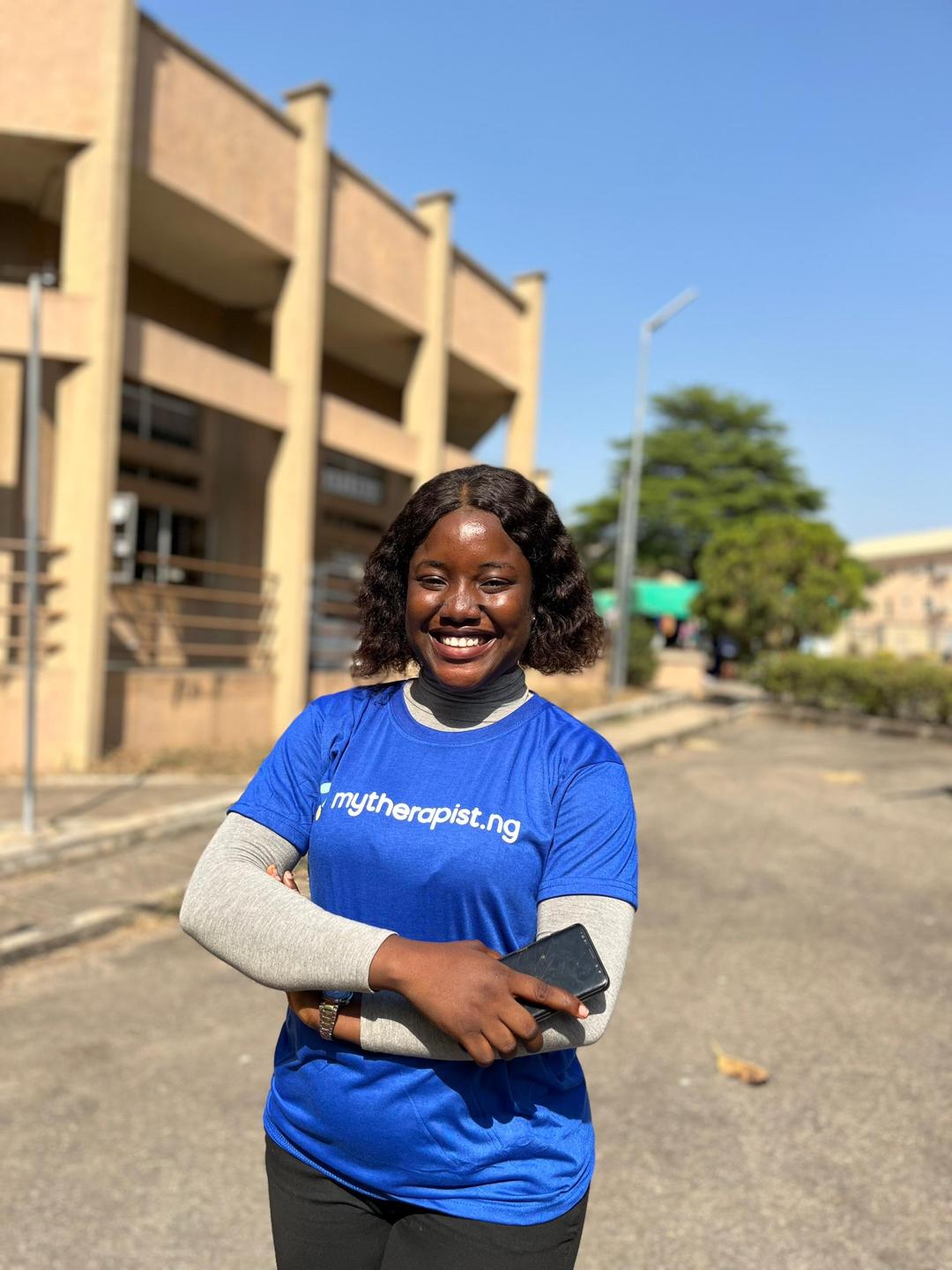 Nigerian student wearing MyTherapist.ng shirt on campus