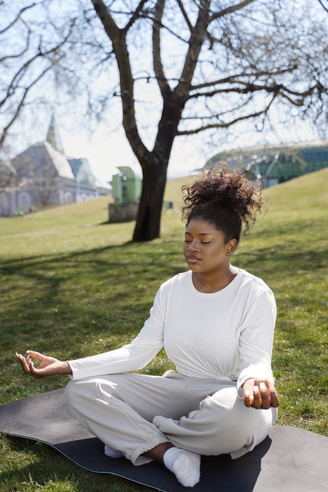 A black woman doing a breathing exercise